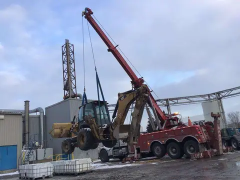Abrams heavy wrecker lifting an excavator