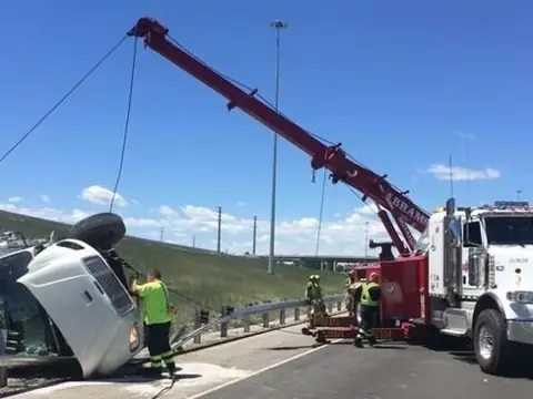 Abrams crew uprighting an overturned trailer on the highway