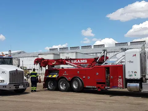 Two Abrams heavy wreckers on a semi truck tow